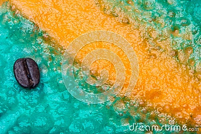 Coffee bean on blue background with yellow scratch. Stock Photo