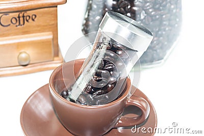 Coffee bean glass bottle in coffee cup Stock Photo