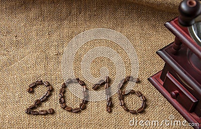 Coffee beans and coffee grinder, close up on the background of burlap sack, 2016 happy new year Stock Photo