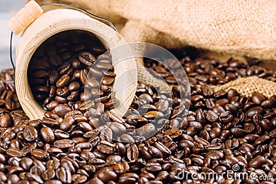 Coffee beans in a decorative bucket on a coffee beans background Stock Photo