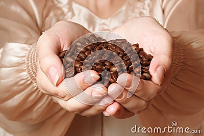 Coffee beans in female hands Stock Photo