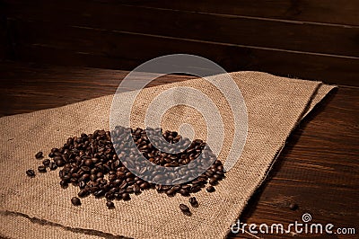 Coffee beans on sacking on the wooden background Stock Photo