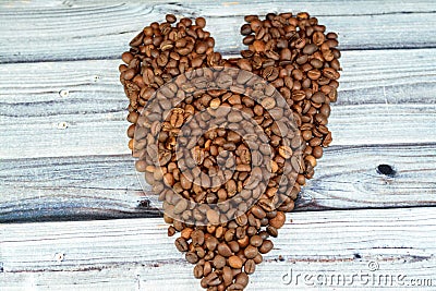 coffee beans, seeds of the Coffea plant and the source for coffee. coffee beans in a heart shaped formation, caffeine lover and Stock Photo