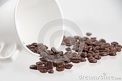 coffee beans spilling out of a mug Stock Photo