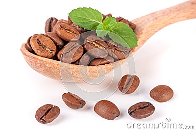 Coffee beans in a wooden spoon with leaf isolated on a white background Stock Photo