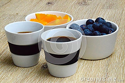 Coffee break with fresh blueberries and orange slices Stock Photo