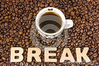 Coffee break photo. Cup with brewed coffee is on table, which filled with roasted coffee beans, next to word break. Idea to design Stock Photo