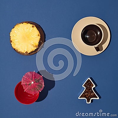 Coffee break with pineapple, drink with parasol, on a blue background. Minimalistic scene Stock Photo