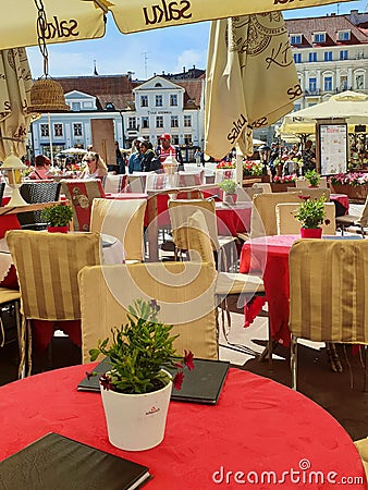 Street Cafe Tables chairs with cup of coffee Flowers City lifestyle Summer Day In Old Town Of Tallinn travel and tourism To Est Editorial Stock Photo