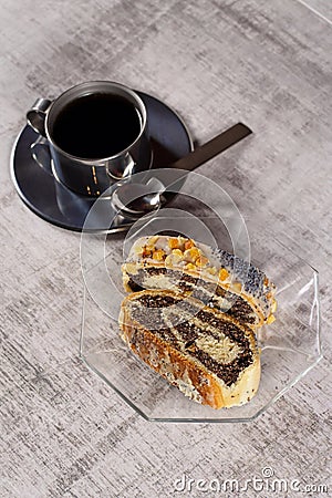 Coffee and cake, poppy seed roll is a pastry consisting of a roll of sweet yeast bread a viennoiserie with a dense, rich, Stock Photo