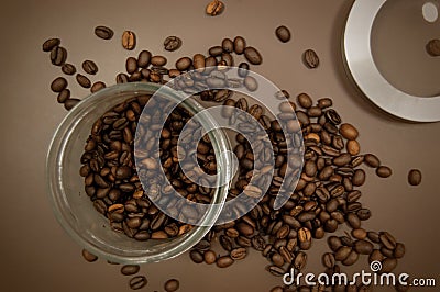 Coffee canister lid and coffee beans scattered on the table Stock Photo
