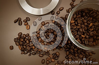 Coffee canister lid and coffee beans scattered on the table Stock Photo