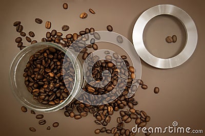 Coffee canister lid and coffee beans scattered on the table Stock Photo