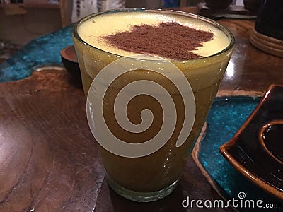 Coffee with cinnamon powder in glass. Stock Photo