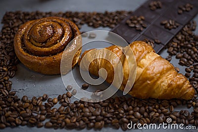 Coffee croissant chocolate breakfast arranged on a gray stone background top view. Photo in a low frame of coffee beans on a gr Stock Photo