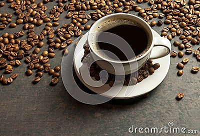 Coffee cup and beans with bright light on black rustic vintage table,Sparkling Coffee concept background. Stock Photo