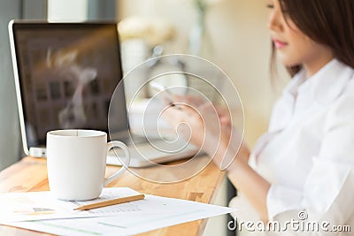 Coffee cup and Businesswoman working with documents and laptop Stock Photo