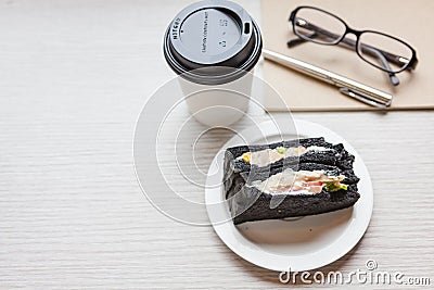 A coffee cup with charcoal sanwiches Stock Photo