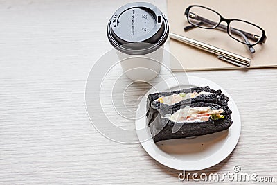 A coffee cup with charcoal sanwiches Stock Photo