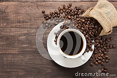 Coffee cup and coffee beans on wooden background. Top view. Stock Photo