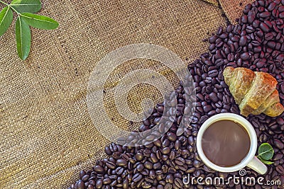 Coffee cup and Croissant on beans and sack Stock Photo