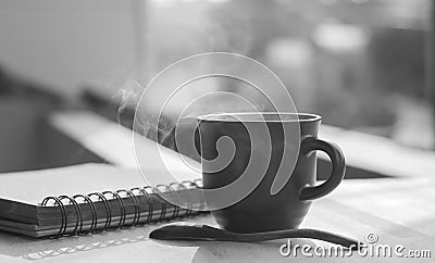 Coffee cup with hot coffee on wood background in morning Stock Photo