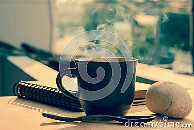 Coffee cup with hot coffee on wood background in morning Stock Photo