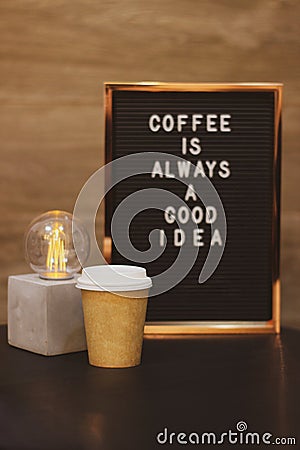 Coffee cup, lamp with background phrase Stock Photo