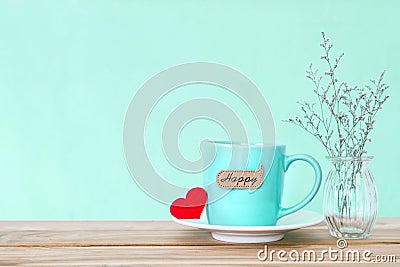 Coffee cup mug with red heart shapeand happy word tag on wooden Stock Photo