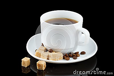 Coffee in a cup and a piece of brown sugar. Coffee drink and coffee beans with sugar Stock Photo