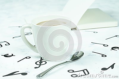 Coffee cup placed on the floor, musical note pattern Stock Photo