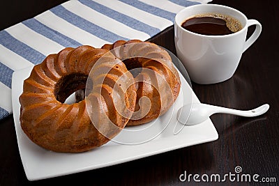 Coffee cup, round cake on table Stock Photo