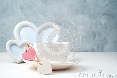 Coffee Cup on a saucer, white frame, hearts on a white-gray background. Stock Photo