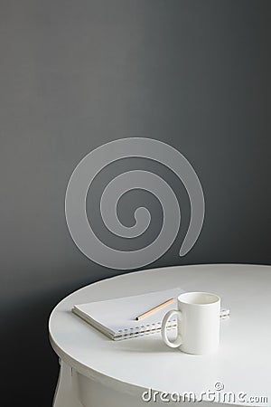 Coffee cup with sketchpad and pencil on white wooden table Stock Photo