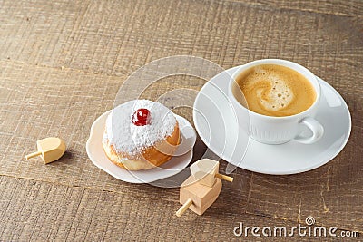 Coffee cup with traditional donuts sufganiyah for Jewish holiday Hanukkah on wooden table Stock Photo