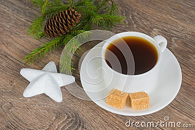 Coffee cup with xmas tree branch and star bauble Stock Photo