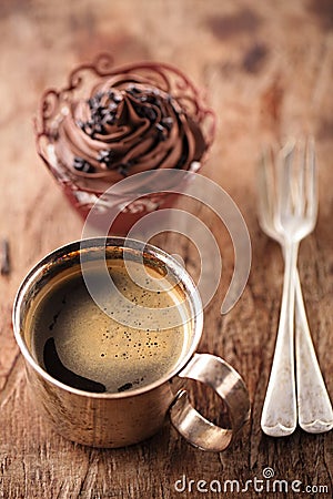 Coffee and cupcake in rustic style on wooden table Stock Photo