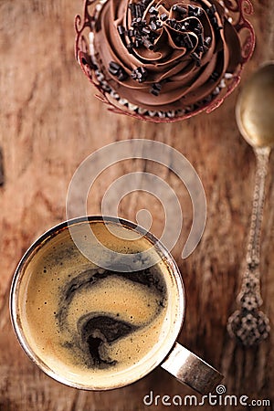 Coffee and cupcake in rustic style on wooden table Stock Photo