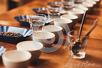 Coffee cups and beans on table ready for a tasting Stock Photo