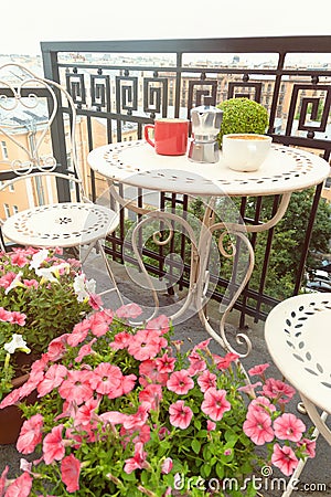 Coffee cups on table on romantic balcony Stock Photo