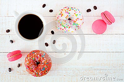 Coffee, donuts and macaroons, flat lay over white wood Stock Photo