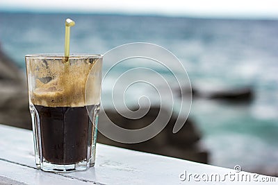 Coffee Frappe Fredo Iced with sea background Stock Photo