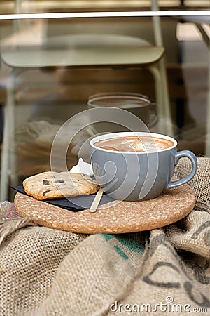 Coffee with froth and coffee beans in a sack Stock Photo