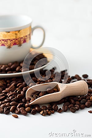 Coffee grains, wooden spoon and white cup Stock Photo