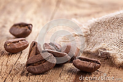 Coffee grains on wooden table Stock Photo