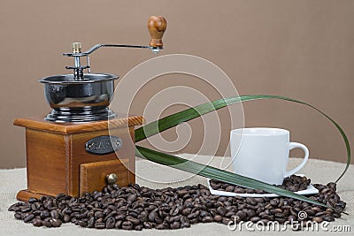Coffee grinder and cups on some bean Stock Photo