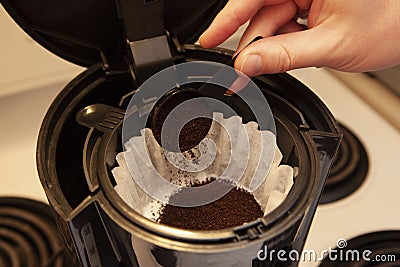 Coffee grinds into the filter Stock Photo