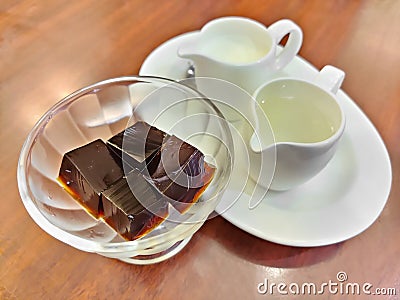 Coffee jelly, jelly dessert flavored made from black coffee and gelatin, serving with milk and syrup. Refreshing dessert for Stock Photo