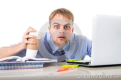 Coffee junkie businessman holding take away cup looking with crazy eyes and funny face expression overworked Stock Photo