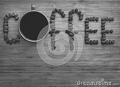 Coffee letters made of beans and cup on vintage boards. Black and white picture Stock Photo